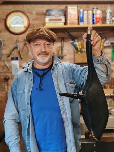 Jaff holding up a bag for a set of pipes that he has made